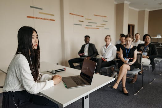 A diverse group of professionals engaged in a business presentation setting.