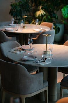 Sophisticated fine dining setup in Tokyo's luxury restaurant, featuring modern decor and ambient lighting.