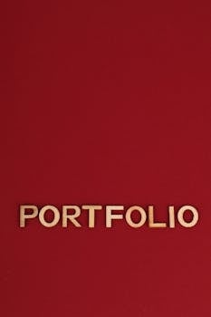 Wooden text spelling 'PORTFOLIO' on a bold red background, ideal for design and business themes.